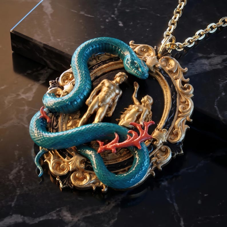 May include: A gold-toned pendant necklace featuring a teal snake wrapped around a framed scene with gold figures. The frame is black and gold, and the snake has red accents. The chain is gold.