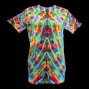 May include: A short-sleeved, tie-dye t-shirt with a vibrant, multicolored pattern. The shirt features a symmetrical design with shades of red, orange, yellow, green, blue, and purple. The overall aesthetic is psychedelic and artistic.