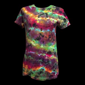 May include: A tie-dye t-shirt in a spectrum of colors, including red, green, purple, and yellow. The shirt has a crew neck and short sleeves. The tie-dye pattern creates a unique, swirling design across the fabric.