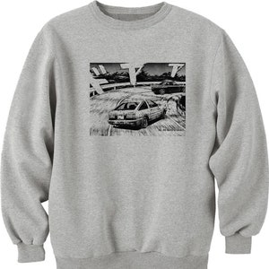 May include: A gray sweatshirt with a black and white illustration of a car drifting on a road. The illustration is from the manga "Initial D" and includes the text "Vol. 24: Battle of Akina".