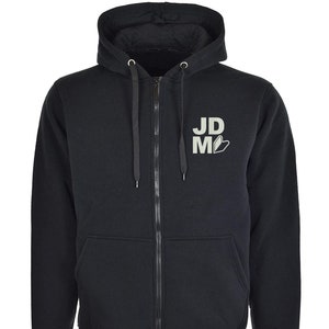 May include: A black zip-up hoodie with a white logo that says "JD.M" on the front.