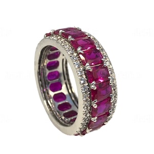 May include: A silver band ring with a row of pink rectangular gemstones and a row of smaller white gemstones.