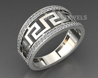 May include: A silver band ring with a geometric design and a row of small clear stones around the edge.