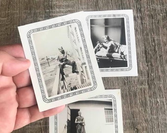 May include: Three black and white photographs in white frames with decorative borders. The photos show a man standing on a porch, a man sitting on a porch, and a man standing in a doorway.