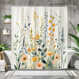 May include: A white shower curtain featuring a watercolor floral design. The artwork showcases a variety of flowers in shades of orange, yellow, and peach, with green and blue foliage. The curtain is hung on a silver rod.