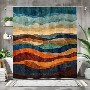 May include: Abstract shower curtain with a colorful, layered design of blue, brown, orange, and yellow hues. The design resembles a landscape with mountains and valleys.