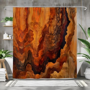 May include: Abstract shower curtain in shades of orange, brown, and black. The design has a flowing, layered pattern, similar to rock formations or geological strata. The curtain is in a bathroom with plants and a white bathtub.
