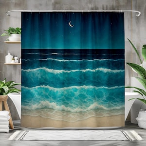 May include: A teal and blue shower curtain depicting a nighttime ocean scene. The design features waves, a sandy beach, a crescent moon, and a starry sky. The curtain is hanging in a bathroom setting.