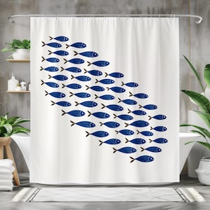 May include: White shower curtain featuring a school of blue fish swimming diagonally across the fabric. The fish have brown tail fins and are arranged in a stylized pattern. The curtain is hanging in a bathroom setting.