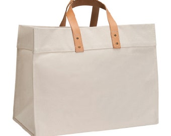 Large canvas tote shopping bag with leather pockets and handles