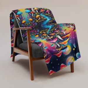 May include: A colorful psychedelic throw blanket featuring a repeating pattern of mushrooms, flowers, and a starry sky. The blanket is draped over a wooden armchair.