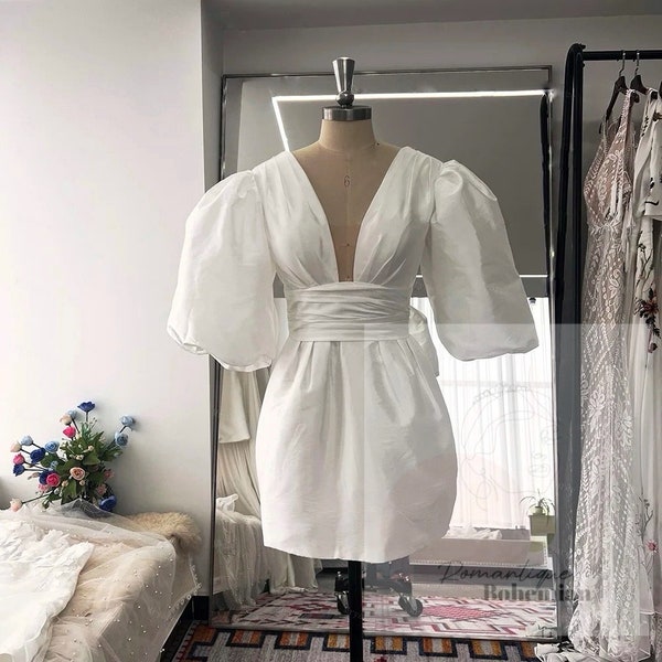 More Dresses @RomantiqueBoho.com Bubble Sleeves Mimi Bridal Dress Plunging Neck Bow Back Short Wedding Dresses With Pockets
