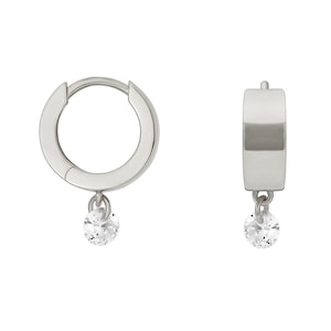 May include: A pair of silver hoop earrings with a small, clear gemstone dangling from each hoop.