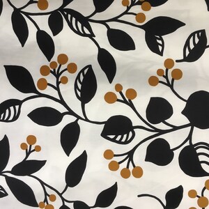 May include: White fabric with a repeating pattern of black leaves and stems, and small, round, golden-brown berries. The design is a botanical or floral print, suitable for textiles or wallpaper.