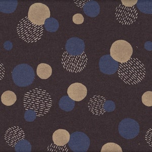 Könnte beinhalten: Dunkelbrauner Stoff mit einem sich wiederholenden Muster aus blauen, beigen und weißen Kreisen. Einige Kreise sind vollflächig, andere haben eine gestrichelte Textur. Das Design ist gleichmäßig über den Stoff verteilt.