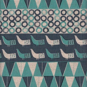May include: Textile fabric with a repeating pattern of teal and white geometric shapes, including triangles, circles, and stylized birds. The design features a mix of teal, white, and dark blue elements on a neutral background.