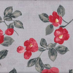 May include: A gray fabric with a repeating pattern of red camellia flowers and green leaves.