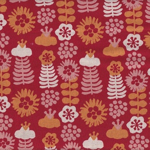 May include: A red fabric with a repeating pattern of stylized flowers, leaves, and other floral elements in white, orange, and light pink. The design has a vintage or folk art aesthetic.