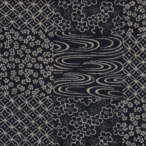 Könnte beinhalten: Marineblauer Stoff mit Patchwork-Design. Das Design umfasst Blumenmuster, geometrische Formen und Wasserwellenmotive in Hellbeige. Der Stoff hat ein strukturiertes Aussehen.