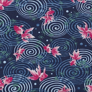 May include: A navy blue fabric featuring a repeating pattern of pink goldfish swimming among blue and white swirling water patterns. Green plant-like elements are interspersed throughout the design, creating a serene aquatic theme.