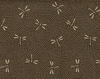 May include: Close-up of a fabric with a repeating pattern of white dragonflies and small white dots on a dark brown background. The dragonfly design is simple and stylized.