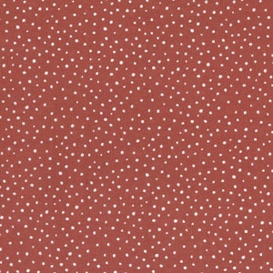 Könnte beinhalten: Nahaufnahme eines terrakottafarbenen Stoffes mit einem sich wiederholenden Muster aus kleinen, unregelmäßig verteilten weißen Punkten. Die Punkte variieren leicht in Größe und Dichte und erzeugen ein strukturiertes Aussehen. Der Stoff hat eine leicht raue, gewebte Textur.