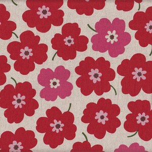 May include: A beige fabric with a repeating pattern of red and pink stylized flowers. The flowers have a simple design with five petals and a small center.