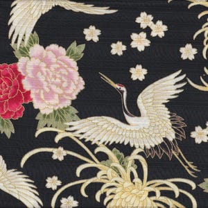 May include: Black fabric with a white crane design, pink and red flowers, and gold accents. The crane is flying with its wings spread wide. The flowers are in bloom and have delicate petals.