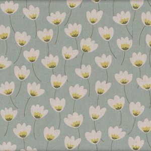 May include: A seamless fabric pattern featuring a repeating design of white stylized flowers with yellow centers on a light blue background.