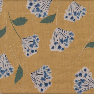May include: A yellow fabric with a repeating pattern of blue and white stylised flowers. The flowers have a delicate, almost watercolour-like appearance.