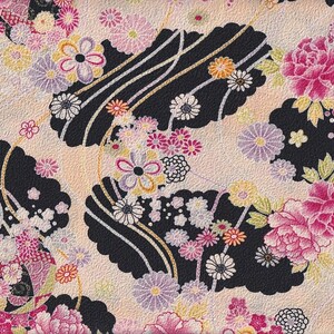 May include: A pink and black floral fabric with a repeating pattern of flowers and leaves. The fabric has a textured surface and a subtle sheen.