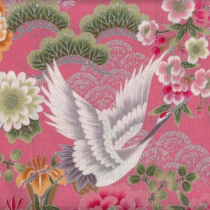 May include: A pink fabric with a white crane flying over a silver and pink floral pattern. The fabric features a repeating pattern of flowers, leaves, and waves.