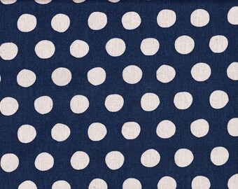 May include: Close-up of a navy blue fabric with a repeating pattern of large, off-white polka dots. The dots are evenly spaced across the surface, creating a classic and playful design. The fabric has a textured appearance.