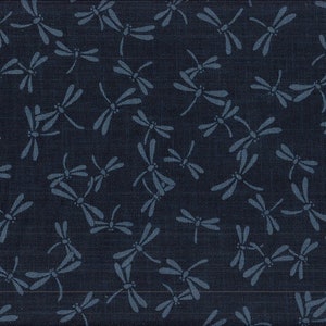 May include: Dark navy blue fabric featuring a repeating pattern of light blue dragonflies. The dragonflies are stylized with delicate wings and bodies, creating a whimsical design. The fabric has a textured appearance.