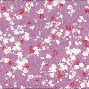 May include: A textured, lavender-colored surface with a repeating pattern of white and red cherry blossoms. The blossoms are clustered along thin, white branches, creating a delicate floral design.