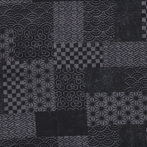 May include: A close-up of a textile with a patchwork design. The fabric is primarily black with various geometric patterns in a lighter gray, including starbursts, checks, and wave motifs. The overall aesthetic is a blend of traditional and modern.
