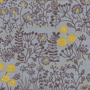 May include: A textile with a repeating floral design. The pattern shows brown and yellow flowers and foliage on a pale blue backdrop. The flowers have yellow centres and brown petals. The fabric has a linen-like texture.