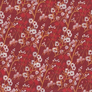 May include: A repeating pattern of stylized floral branches in shades of red, white, and gold against a deep red background. The design features clusters of small white flowers and red berries, creating a textured, all-over print suitable for fabric or wallpaper.