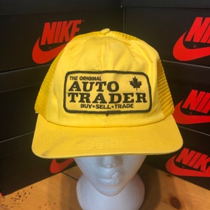 May include: Yellow trucker hat with a black patch that says "The Original Auto Trader Buy-Sell-Trade" with a Canadian maple leaf.