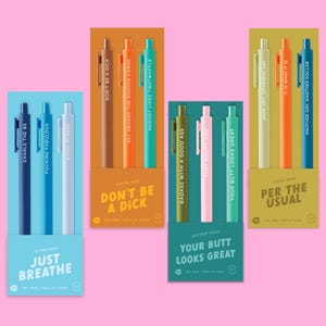 May include: Four sets of three gel pens in blue, orange, teal, and yellow packaging. Each pen features printed text including phrases like EXHALE THE BS, DON'T BE A DICK, BADASS WITH A GOOD ASS, and SAME SHIT, DIFFERENT DAY. The packaging displays the set names.