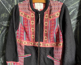 May include: Black zip-up jacket with colorful embroidered panels and a 'Monsoon' label. The jacket has a geometric pattern and is made of a textured fabric.