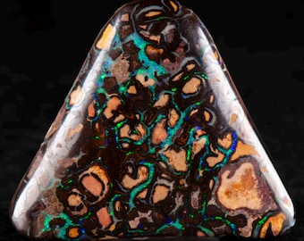 May include: A polished, triangular-shaped gemstone with a dark brown base color. The stone features intricate patterns of orange, green, and blue, creating a unique and eye-catching appearance. The gemstone is likely an opal.