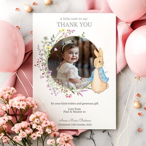 May include: A thank you card with a floral wreath and a photo of a baby girl. The card also features a cartoon rabbit and the text "A little note to say THANK YOU for your kind wishes and generous gift Love from Paul & Maxine xx Anne Marie Clerkson Christened 12th October 2023".