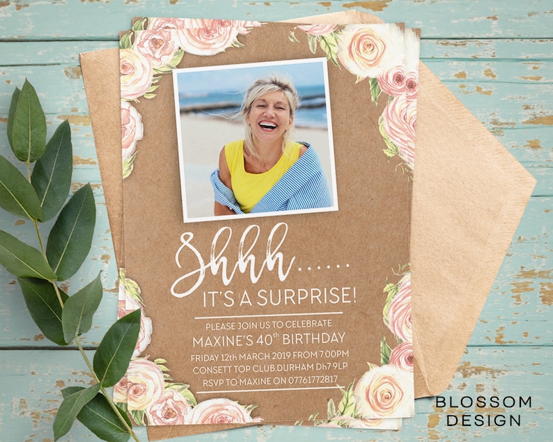 May include: A kraft paper birthday invitation with a floral border and a photo of a woman smiling. The text reads "Shhh... It's a surprise!" and includes details for a 40th birthday party.