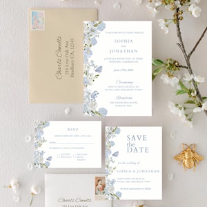 May include: Wedding invitation suite featuring floral and butterfly accents in shades of blue and white. Includes an invitation, RSVP card, and a "Save the Date" card. The suite is adorned with the names "Sophia & Jonathan" and event details.