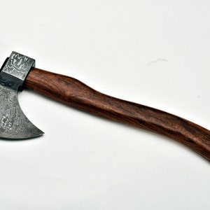 May include: A small axe with a dark wood handle and a patterned steel head.