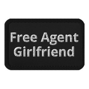 May include: Black rectangular patch with the embroidered text "Free Agent Girlfriend" in white. The patch has a black border with a stitched texture, and the text is in a bold, sans-serif font.