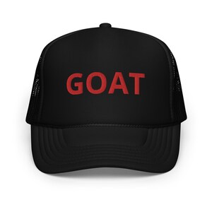 May include: Black trucker hat with a red embroidered "GOAT" on the front.