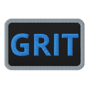 May include: A black and gray embroidered patch with the word "GRIT" in blue lettering.