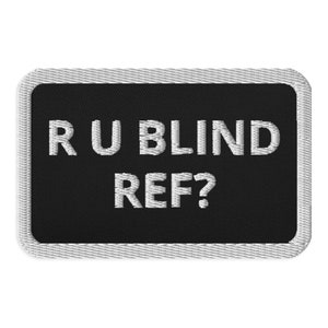 May include: Black and white embroidered patch with the text "RU BLIND REF?" in white lettering.